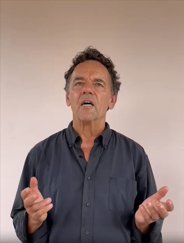 Middle-aged man speaking, gesturing with hands